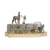 Toy set with horses, a person, and farm tools on a wooden base with a ruler for scale.