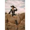 Woman in cowboy hat and boots sitting on a horse with a scenic background