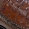 Close-up of brown leather shoe with detailed stitching