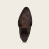 Close-up of a dark brown leather boot sole on a light beige background