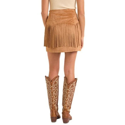 Person wearing a brown suede skirt and cowboy boots on a white background