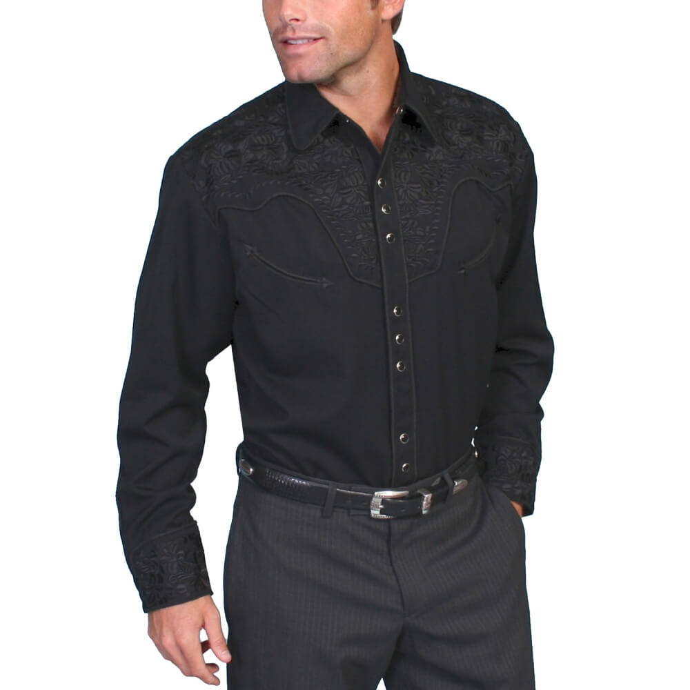 Man wearing a black embroidered shirt and pants on a white background