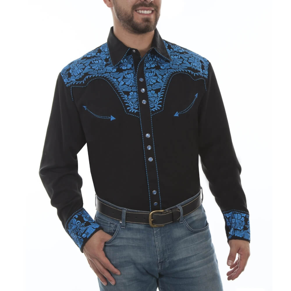 Man wearing a black western-style shirt with blue embroidery on a white background