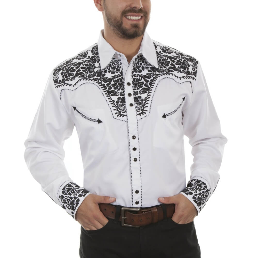 Man wearing a white shirt with black floral embroidery on a white background