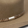 Close-up of a brown Stetson hat with braided leather chin strap.
