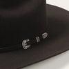 Black cowboy hat with a silver buckle on a white background