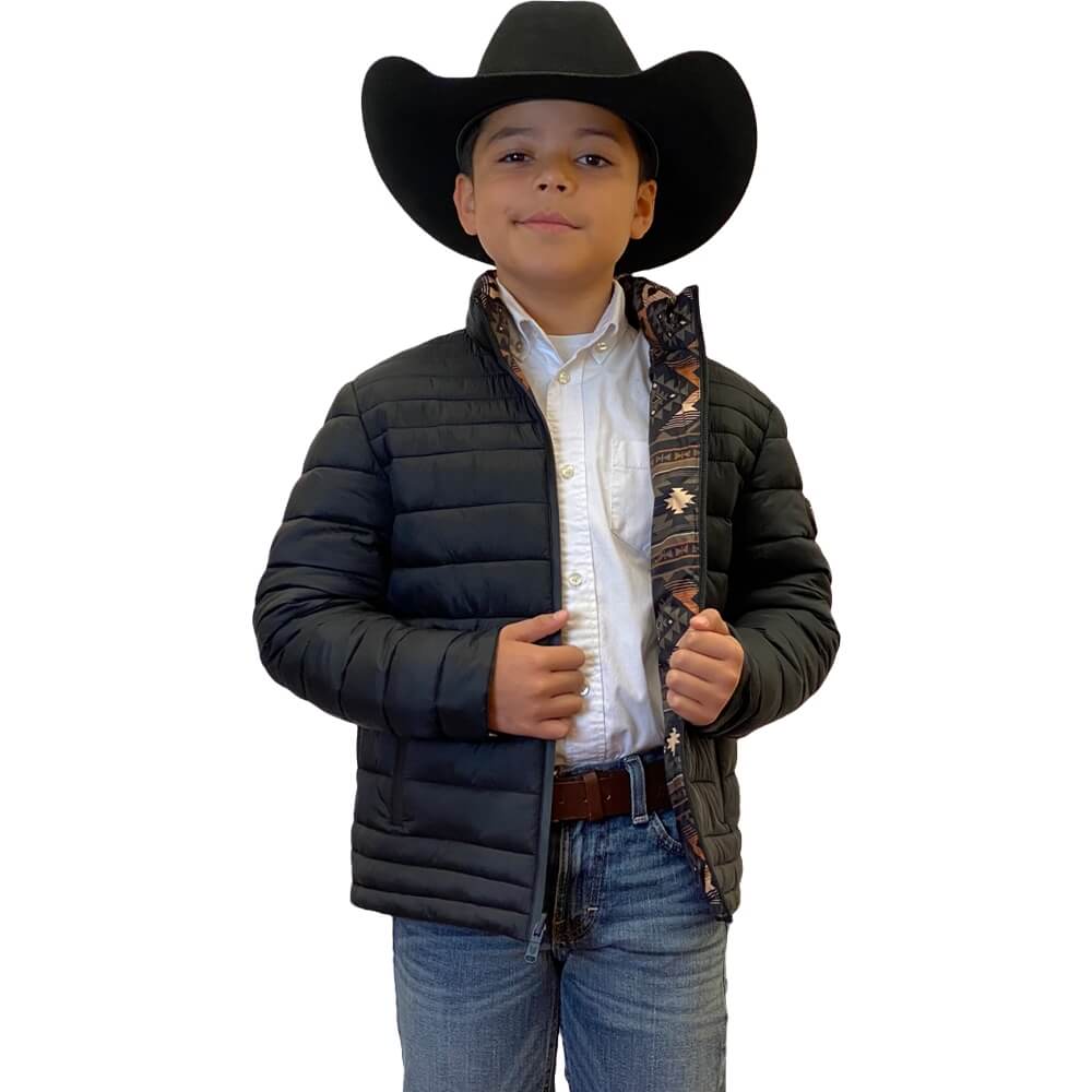 Child wearing a black puffer jacket, white shirt, jeans, and cowboy hat on a white background
