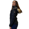Woman wearing a black puffer jacket with fur trim on a white background